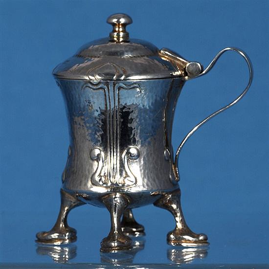 An Edwardian Arts and Crafts Cymric silver mustard pot, designed by Archibald Knox, for Liberty & Co, numbered 409, height 70mm,